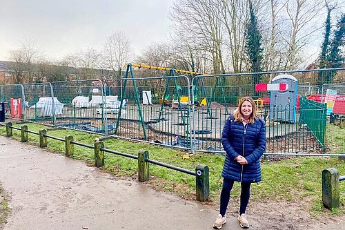 Cllr Kim Tonks standing in front of the Bratton Play Area as work on the refit progresses.